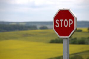 stop sign in front of a field